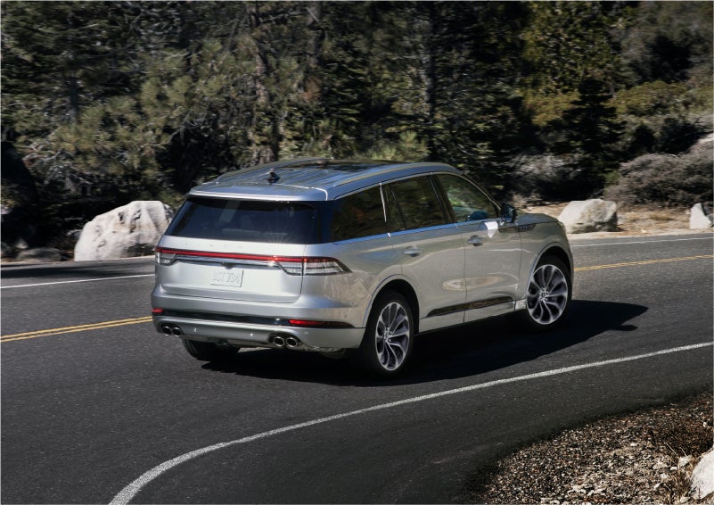 A 2023 Lincoln Aviator® Grand Touring model is shown being driven on a tight turn of a mountain road | Bergstrom Lincoln of Neenah in Neenah WI