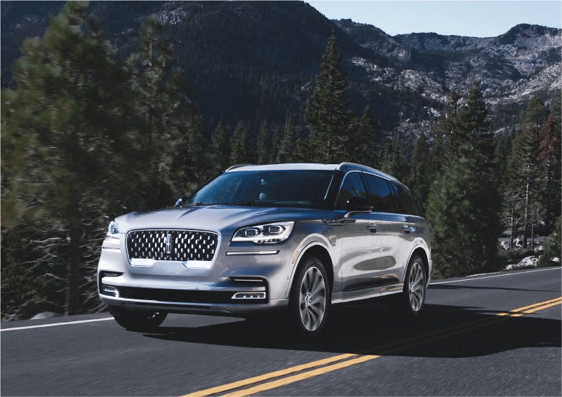 A 2023 Lincoln Aviator® Grand Touring SUV being driven on a winding road to demonstrate the capabilities of all-wheel drive | Bergstrom Lincoln of Neenah in Neenah WI