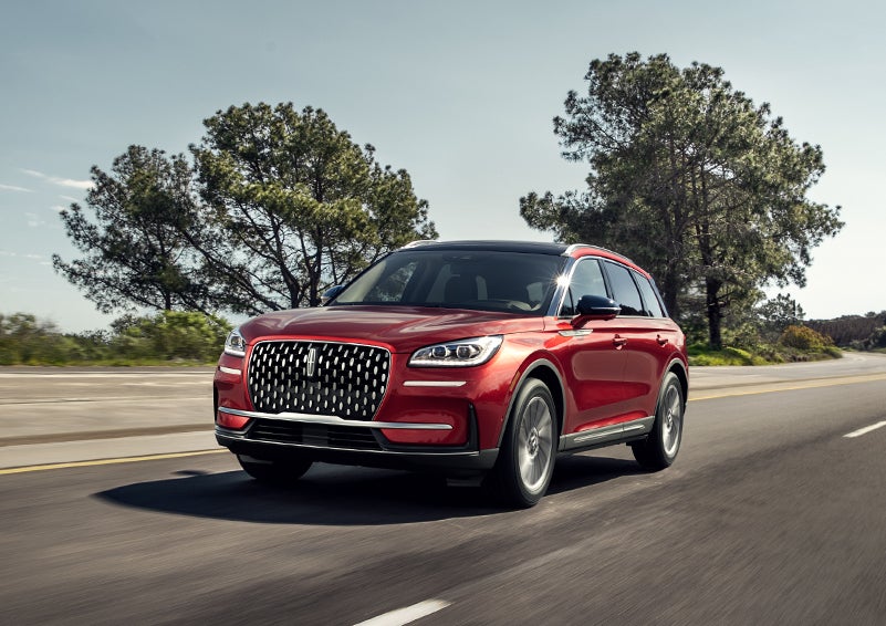 A 2023 Lincoln Corsair® SUV is shown being driven on a country road. | Bergstrom Lincoln of Neenah in Neenah WI