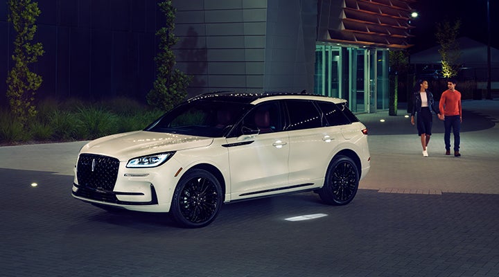 Two people approach a 2024 Lincoln Corsair® SUV featuring the available Jet Appearance Package. | Bergstrom Lincoln of Neenah in Neenah WI