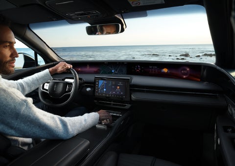 A driver of a parked 2024 Lincoln Nautilus® SUV takes a relaxing moment at a seaside overlook while inside his Nautilus. | Bergstrom Lincoln of Neenah in Neenah WI