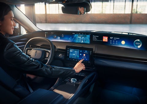 The driver of a 2024 Lincoln Nautilus® SUV interacts with the center touchscreen. | Bergstrom Lincoln of Neenah in Neenah WI