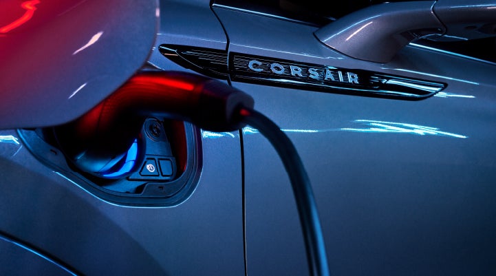 A charger plugged into the charging port of a 2024 Lincoln Corsair® Plug-in Hybrid model. | Bergstrom Lincoln of Neenah in Neenah WI