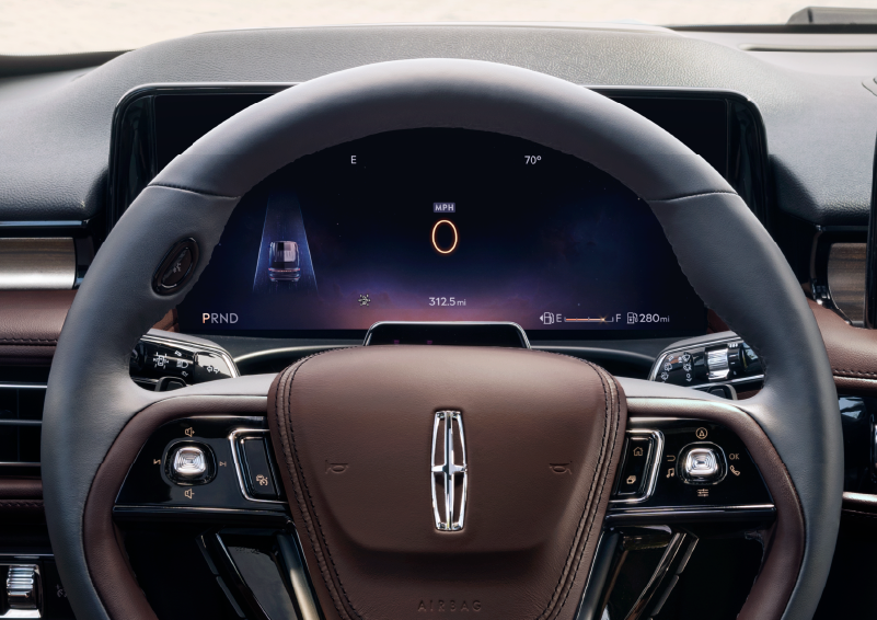 The steering wheel of 2025 Lincoln Aviator® SUV is shown with black and brown accents. | Bergstrom Lincoln of Neenah in Neenah WI