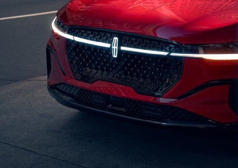 The available front LED light bar and center Lincoln Star logo glow at dusk. | Bergstrom Lincoln of Neenah in Neenah WI
