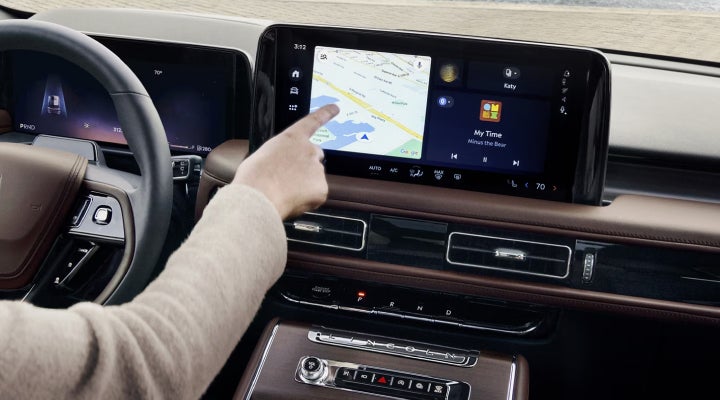 A person is tapping the center display touchscreen of a 2026 Lincoln Aviator® SUV. | Bergstrom Lincoln of Neenah in Neenah WI