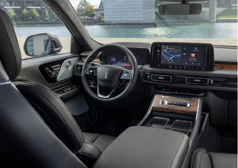 The interior of the 2026 Lincoln Aviator® SUV is shown parked with a view of a harbor through the windshield. | Bergstrom Lincoln of Neenah in Neenah WI