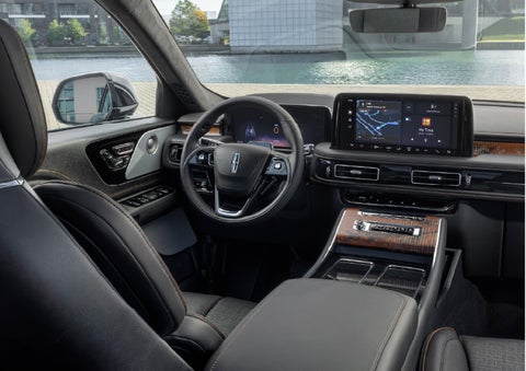 The interior of the 2026 Lincoln Aviator® SUV is shown parked with a view of a harbor through the windshield. | Bergstrom Lincoln of Neenah in Neenah WI