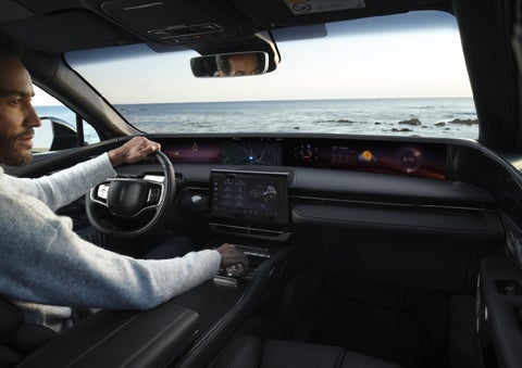 A driver of a parked 2026 Lincoln Nautilus® SUV takes a relaxing moment at a seaside overlook while inside his Nautilus. | Bergstrom Lincoln of Neenah in Neenah WI