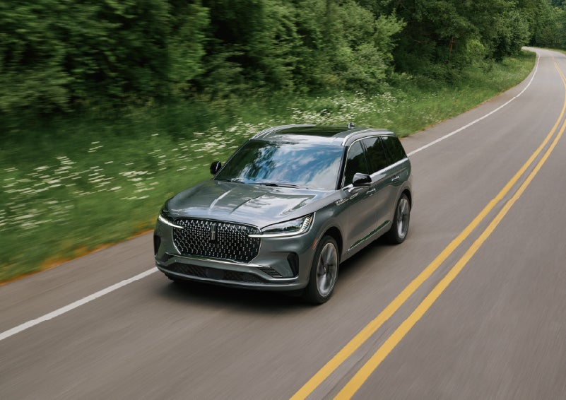 A 2027 Lincoln Aviator® SUV is being driven down a road. | Bergstrom Lincoln of Neenah in Neenah WI