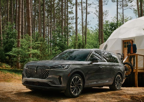 A 2027 Lincoln Aviator® is parked next to a high end glamping site. | Bergstrom Lincoln of Neenah in Neenah WI