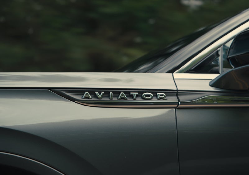 The driver’s side door and fender badging of a gray 2027 Lincoln Aviator® SUV are showcased. | Bergstrom Lincoln of Neenah in Neenah WI