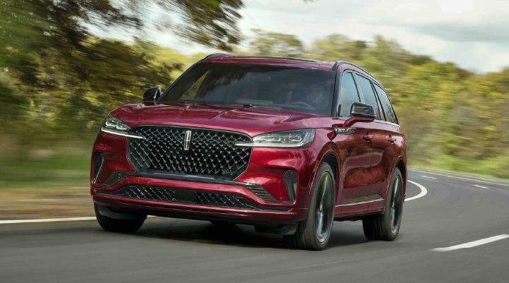 A 2027 Lincoln Aviator® SUV is being driven on a country road | Bergstrom Lincoln of Neenah in Neenah WI