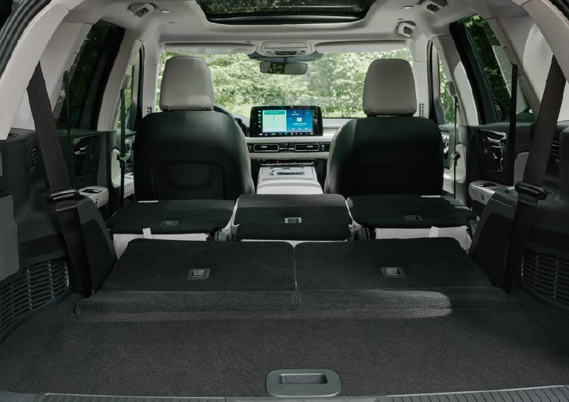 A rear to front view of the interior of a 2027 Lincoln Aviator® Black Label™ SUV shows the third and second rows folded flat | Bergstrom Lincoln of Neenah in Neenah WI